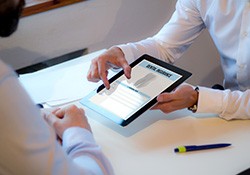 Patient reviewing dental insurance form on tablet