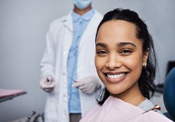 Woman smiling while sitting in treatment chair