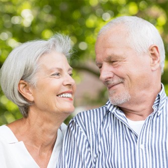 older couple smiling at each other 