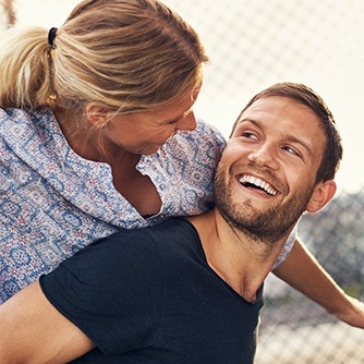 Smiling man and woman outdoors