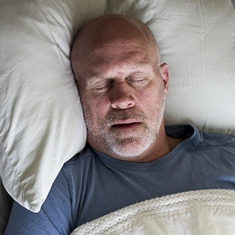 Man sleeping soundly in bed