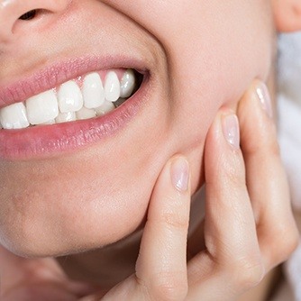 Woman holding jaw in pain