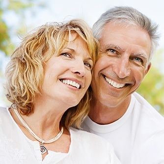 Smiling older man and woman outdoors