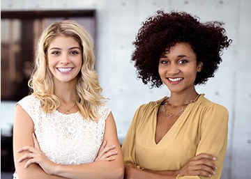 Two young women with flawless smile