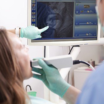 Dentist and patient looking at intraoral photos