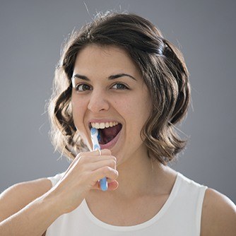 Woman brushing her teeth