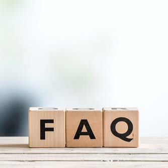 Three wooden letter blocks spelling FAQ