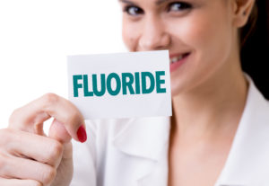 Woman holding a fluoride sign