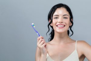 Healthy woman with toothbrush practices great oral hygiene during COVID-19