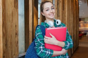 Teenage girl with folder and backpack