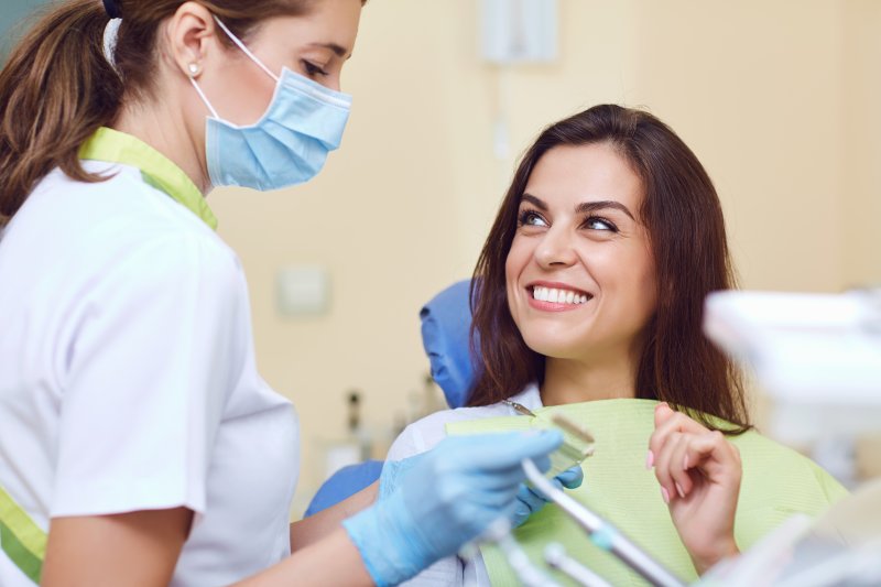 dentist speaking to patient about color-matching dental crowns