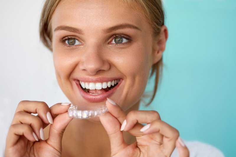 Woman using DIY teeth whitening tray
